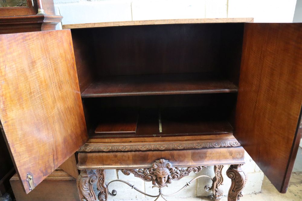 An Italian style walnut oyster veneered cabinet on stand, width 96cm depth 50cm height 147cm